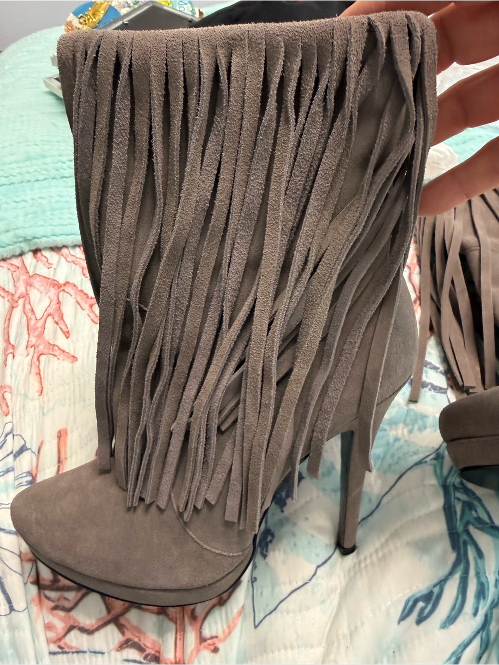 Lunching stiletto fringe boots with red heart on sole.